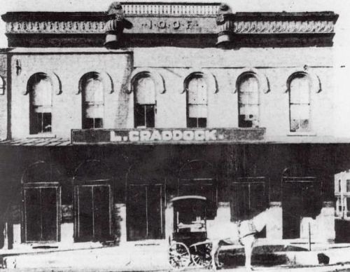 The first location, at Main & Austin, with theater on second floor (1880s)